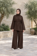 Hijabi model wearing the dark brown set outdoors