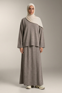 Taupe knit sweater and maxi skirt on a hijabi model in a neutral studio